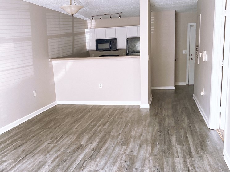 empty Fayetteville apartment living room and kitchen with wood-look flooring